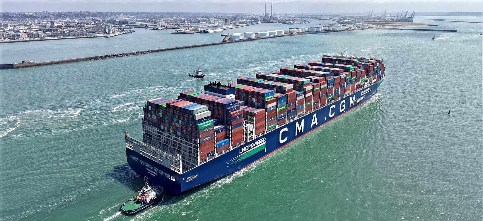 A loaded container ship leaving port, seen from above